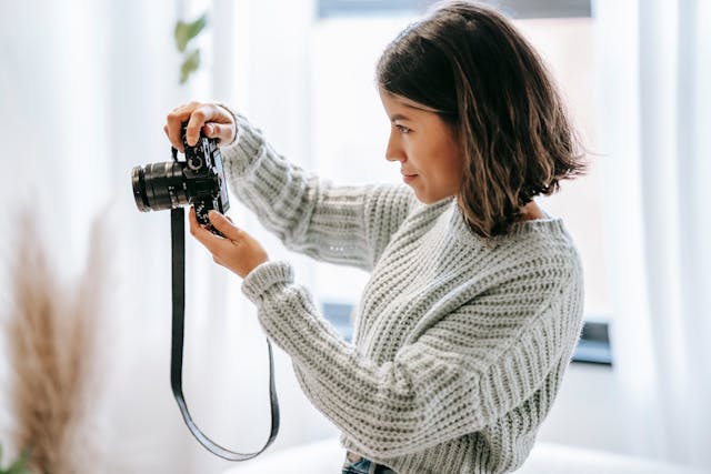 Person taking pictures inside a home